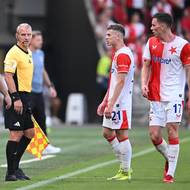 Trenér Slavie Jindřich Trpišovský a hráči Slavie řeší s čárovým rozhodčím sporný moment v zápase proti Hradci.